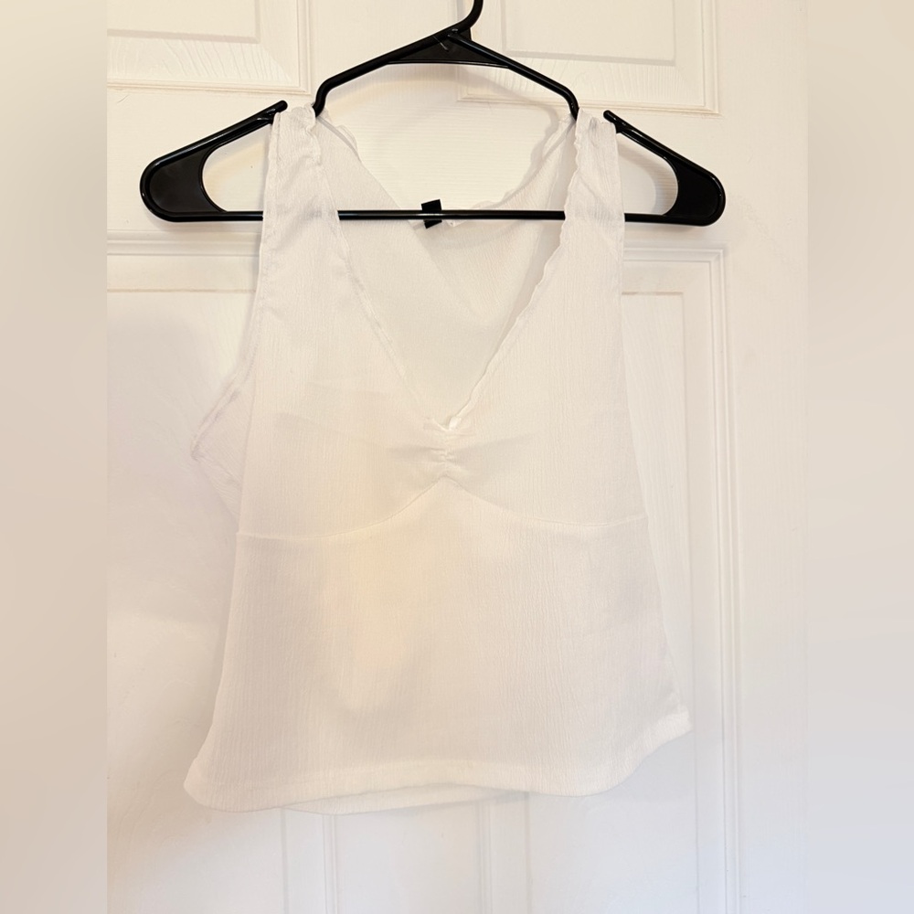 Super cute white cropped top with bow on front!